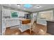 The kitchen showcases an island, white cabinetry, a window, and an eat-in area at 1920 Hillock Dr, Raleigh, NC 27612