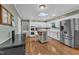 Well-lit kitchen featuring a stainless steel refrigerator, center island, and white cabinetry at 1920 Hillock Dr, Raleigh, NC 27612
