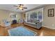 Comfortable living room area, features hardwood floors and large window at 1920 Hillock Dr, Raleigh, NC 27612