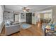 Cozy living room with hardwood floors, built-in shelving, a ceiling fan, and gray sofa at 1920 Hillock Dr, Raleigh, NC 27612
