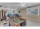 Comfortable living room features a foosball table, couch, and many windows allowing natural light at 1920 Hillock Dr, Raleigh, NC 27612