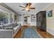 Comfortable living room featuring hardwood floors, built-in shelving, a ceiling fan, and gray sofa at 1920 Hillock Dr, Raleigh, NC 27612