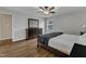 The light-filled main bedroom features a large dresser, wood floors, and ample space for relaxation at 1920 Hillock Dr, Raleigh, NC 27612