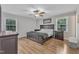 The main bedroom boasts two windows with natural light and a king-size bed with matching nightstands at 1920 Hillock Dr, Raleigh, NC 27612