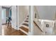 Traditional staircase with wood treads, white risers, and a wooden handrail at 1920 Hillock Dr, Raleigh, NC 27612