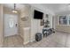 Bright workout room with tiled floors and a door features a television and weights at 1920 Hillock Dr, Raleigh, NC 27612