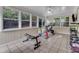 Bright workout room with tiled floors and many windows features a stationary bike and weights at 1920 Hillock Dr, Raleigh, NC 27612