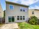 The backyard has a sliding door, green grass and an air conditioning unit at 2072 Tanners Mill Dr, Durham, NC 27703
