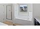 Bright bathroom with a separate shower and a soaking tub with a window view at 2072 Tanners Mill Dr, Durham, NC 27703