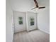 This bright bedroom features two windows, neutral carpet, and white walls at 2072 Tanners Mill Dr, Durham, NC 27703