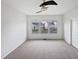 Empty bedroom boasts three windows, neutral carpet, white walls and ample space at 2072 Tanners Mill Dr, Durham, NC 27703