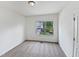 This carpeted bedroom has a window with a view, neutral walls, and a ceiling light at 2072 Tanners Mill Dr, Durham, NC 27703