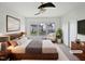 This virtually staged bedroom features a ceiling fan, large window, and comfortable furnishings at 2072 Tanners Mill Dr, Durham, NC 27703