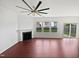 Bright, spacious living room with a fireplace, a large ceiling fan and a sliding glass door at 2072 Tanners Mill Dr, Durham, NC 27703