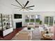 Staged living room featuring a fireplace, a ceiling fan and three windows for natural light at 2072 Tanners Mill Dr, Durham, NC 27703