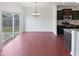 This spacious living room features wood floors, a sliding door, and modern light fixtures at 2072 Tanners Mill Dr, Durham, NC 27703