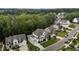 Aerial view of a neighborhood with large homes, lush landscaping, and tree lined streets at 2077 Amalfi Pl, Apex, NC 27502