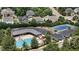 Community pool featuring lush landscaping, clubhouse, tennis court, and ample parking at 2077 Amalfi Pl, Apex, NC 27502