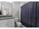 Bathroom featuring modern vanity, large mirror, toilet, and shower with patterned curtain at 2077 Amalfi Pl, Apex, NC 27502