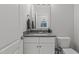 Stylish bathroom featuring a vanity with a sink, a mirror, and a toilet, all in neutral colors at 2077 Amalfi Pl, Apex, NC 27502