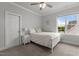 Bright bedroom with white furniture, neutral walls, ceiling fan, and a window view of the outdoors at 2077 Amalfi Pl, Apex, NC 27502