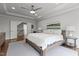 Bedroom featuring a wooden bed frame, tray ceiling, ceiling fan, and view of landing at 2077 Amalfi Pl, Apex, NC 27502