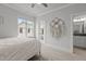 Bright bedroom with neutral decor, carpet, window with view, and doorway to bathroom at 2077 Amalfi Pl, Apex, NC 27502