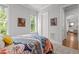 Cozy bedroom featuring natural light, a comfortable bed with colorful bedding, and neutral walls at 2077 Amalfi Pl, Apex, NC 27502