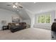Relaxing bonus room with comfortable seating, natural light, and neutral colors for a cozy atmosphere at 2077 Amalfi Pl, Apex, NC 27502