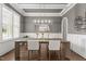 Dining room featuring modern lighting, wainscoting, and large windows at 2077 Amalfi Pl, Apex, NC 27502