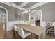 Open dining area with contemporary lighting and elegant decor, open to other living areas at 2077 Amalfi Pl, Apex, NC 27502