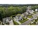 Two-story home featuring manicured lawns, gray roof, attached garages, and mature trees at 2077 Amalfi Pl, Apex, NC 27502