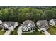 Two-story home featuring manicured lawns, gray roof, attached garages, and mature trees at 2077 Amalfi Pl, Apex, NC 27502