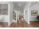 Bright hallway with hardwood floors, staircase, and elegant architectural details at 2077 Amalfi Pl, Apex, NC 27502
