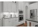Kitchen features stainless steel appliances, white cabinets, and a light-colored stone countertop at 2077 Amalfi Pl, Apex, NC 27502