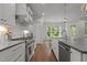 Spacious kitchen featuring stainless steel appliances, hardwood floors, and white cabinets at 2077 Amalfi Pl, Apex, NC 27502