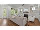 Bright living room with fireplace, built-in shelving, and large windows offering a view of the outdoors at 2077 Amalfi Pl, Apex, NC 27502
