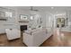 An inviting living room showcasing a brick fireplace, built-in shelving, and elegant hardwood floors at 2077 Amalfi Pl, Apex, NC 27502