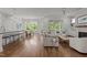 Open-concept living space with hardwood floors, fireplace, and seamless flow to dining area at 2077 Amalfi Pl, Apex, NC 27502