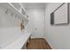 Mudroom with built-in bench seating, hooks, and shelving, offering organization and style at 2077 Amalfi Pl, Apex, NC 27502