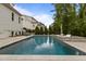 Backyard featuring a luxurious pool, lounge chairs, and lush landscaping at 2077 Amalfi Pl, Apex, NC 27502