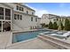 Backyard featuring a luxury pool, lounge chairs, and spa at 2077 Amalfi Pl, Apex, NC 27502