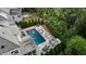Aerial view of a rectangular in-ground pool, lounge chairs, manicured landscape, and outdoor seating at 2077 Amalfi Pl, Apex, NC 27502