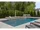 Backyard featuring a luxurious pool, spa, and lush green landscaping at 2077 Amalfi Pl, Apex, NC 27502