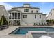 Backyard pool area with lounge chairs, screened in porch and staircase to a second floor terrace at 2077 Amalfi Pl, Apex, NC 27502