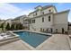 Backyard featuring a luxury pool, lounge chairs, screened-in porch, and outdoor dining at 2077 Amalfi Pl, Apex, NC 27502