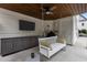 Covered outdoor patio with a swing, TV, and cabinets at 2077 Amalfi Pl, Apex, NC 27502