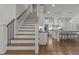 Staircase leading into a bright kitchen with a large center island at 2077 Amalfi Pl, Apex, NC 27502
