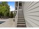 Exterior view of a stairway leading to a screened-in porch of a charming home at 2077 Amalfi Pl, Apex, NC 27502