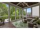 Inviting screened-in porch with wood ceiling and floors, and wicker furniture offers a serene outdoor retreat at 2077 Amalfi Pl, Apex, NC 27502